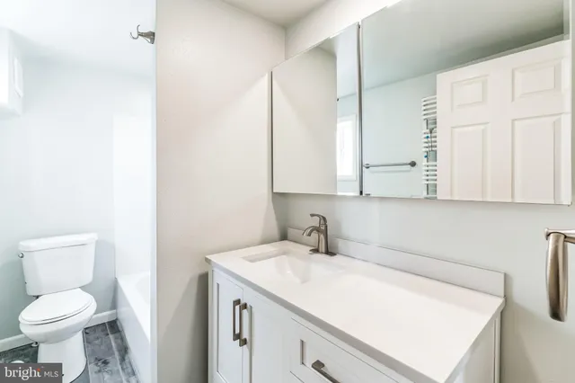 a bathroom with a sink toilet and mirror