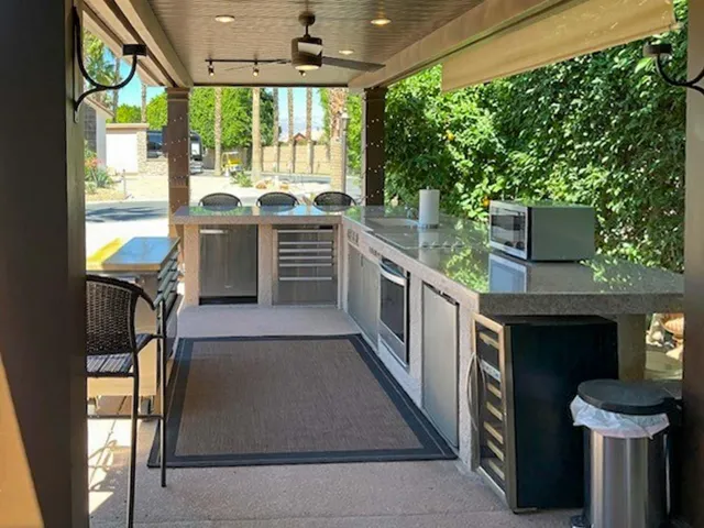 a kitchen with stainless steel appliances a stove a sink and a refrigerator