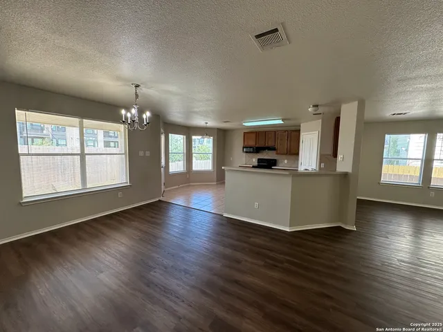 a view of a kitchen with a sink and dishwasher a kitchen island with wooden floor