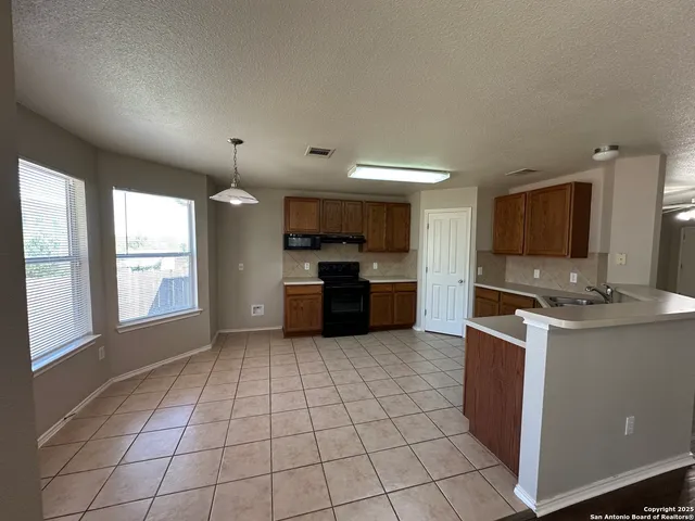 a kitchen with stainless steel appliances granite countertop a sink and cabinets