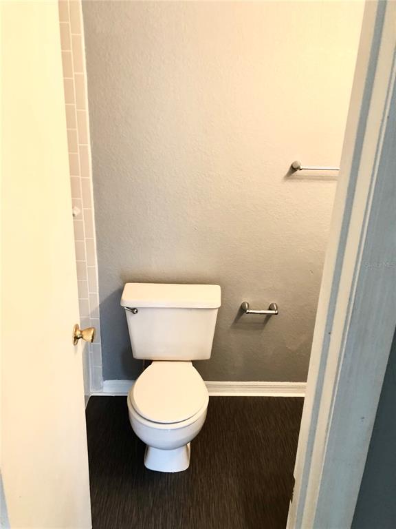 1037 South Hiawassee Road, Unit 2835 Orlando, FL 32835 - Photo 11 of 18 a white toilet sitting next to a sink