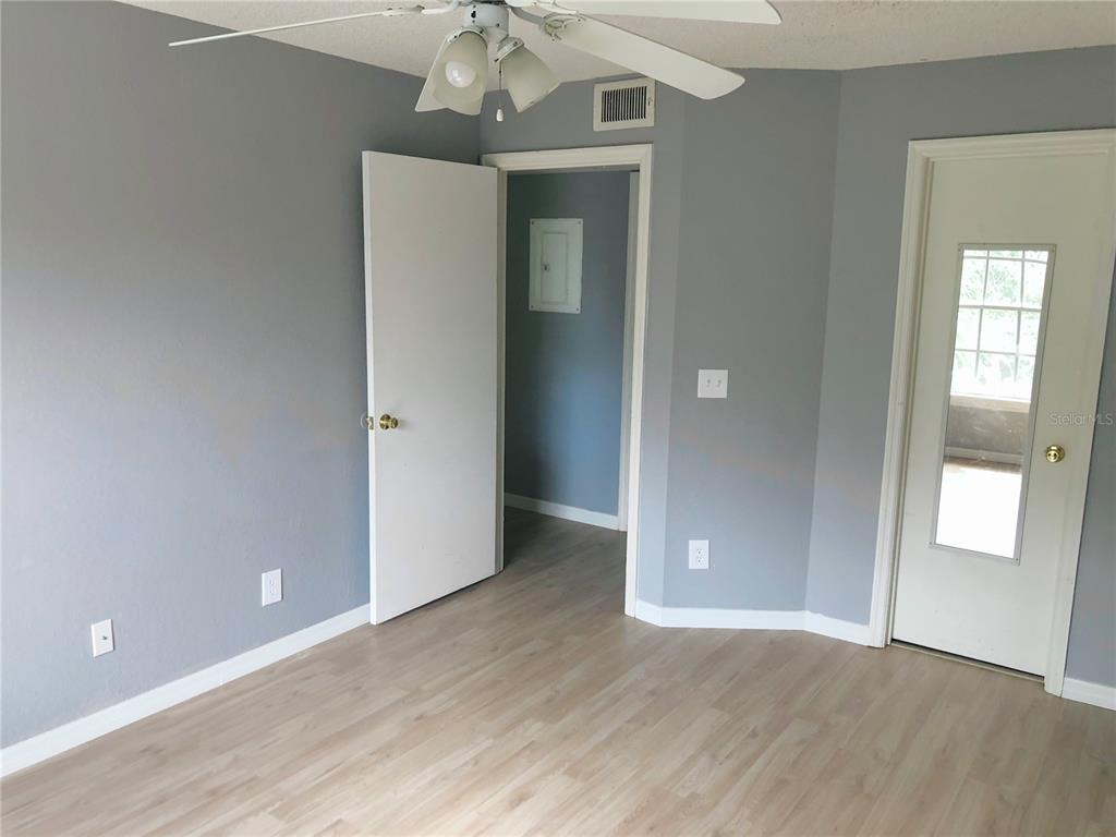1037 South Hiawassee Road, Unit 2835 Orlando, FL 32835 - Photo 16 of 18 wooden floor in an empty room with a window