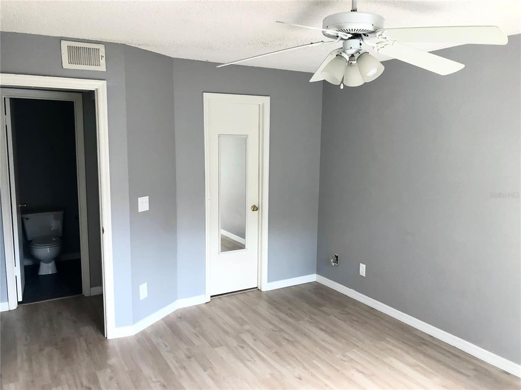 1037 South Hiawassee Road, Unit 2835 Orlando, FL 32835 - Photo 17 of 18 wooden floor in an empty room with a window