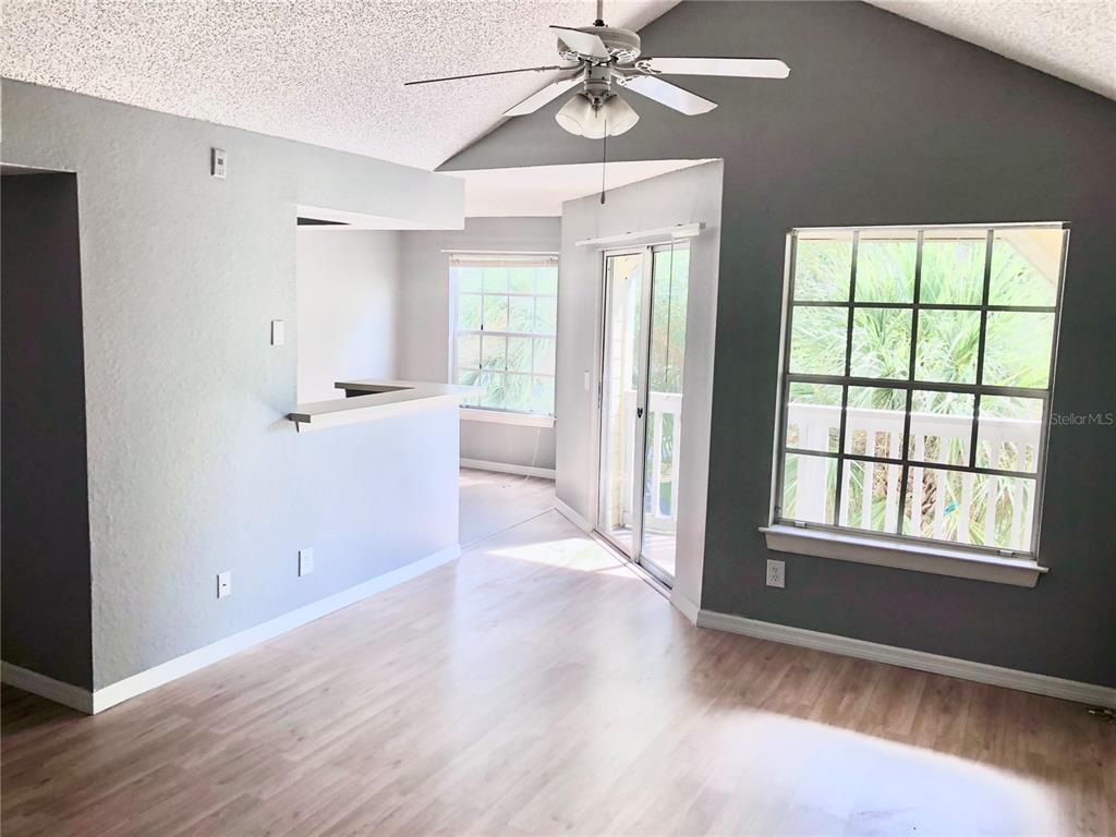 1037 South Hiawassee Road, Unit 2835 Orlando, FL 32835 - Photo 3 of 18 a view of an empty room with a window and wooden floor