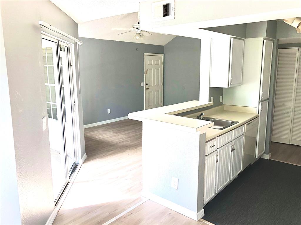 1037 South Hiawassee Road, Unit 2835 Orlando, FL 32835 - Photo 5 of 18 a kitchen that has a sink a stove and a refrigerator