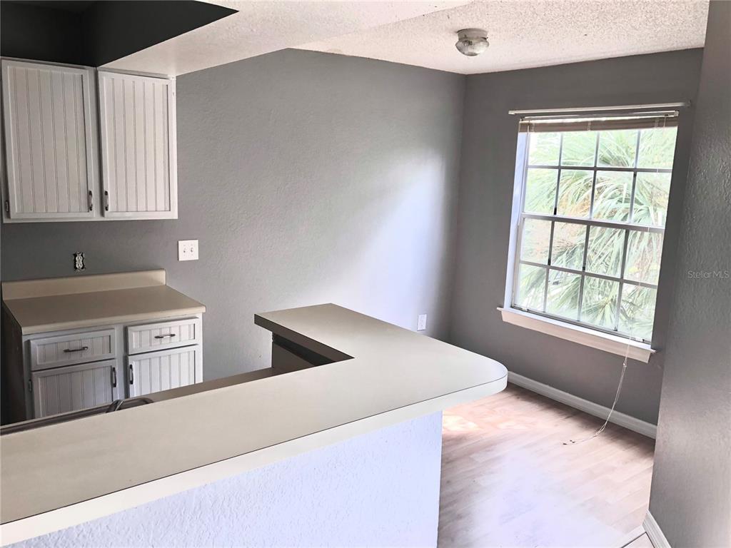 1037 South Hiawassee Road, Unit 2835 Orlando, FL 32835 - Photo 7 of 18 a kitchen that has a stove and a refrigerator