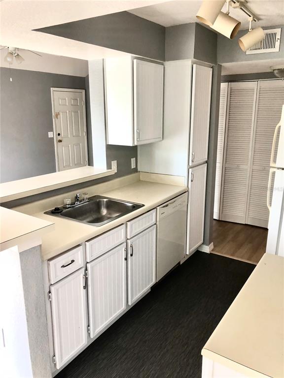 1037 South Hiawassee Road, Unit 2835 Orlando, FL 32835 - Photo 8 of 18 a kitchen with granite countertop white cabinets and refrigerator
