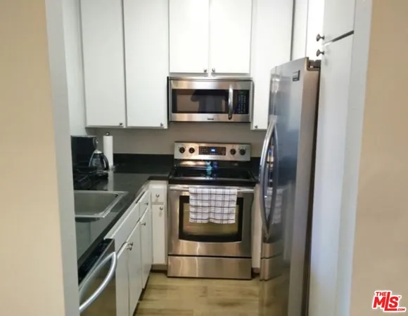 a bed sitting in a bedroom next to a bathroom