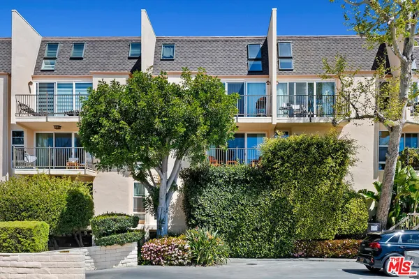 front view of a building with potted plants
