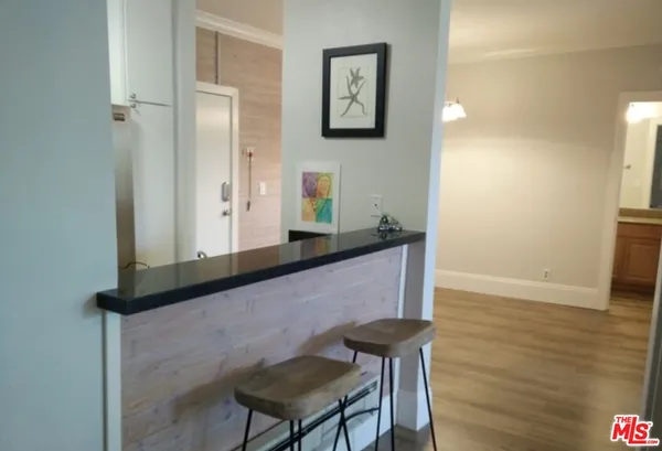 a view of kitchen with cabinets and wooden floor