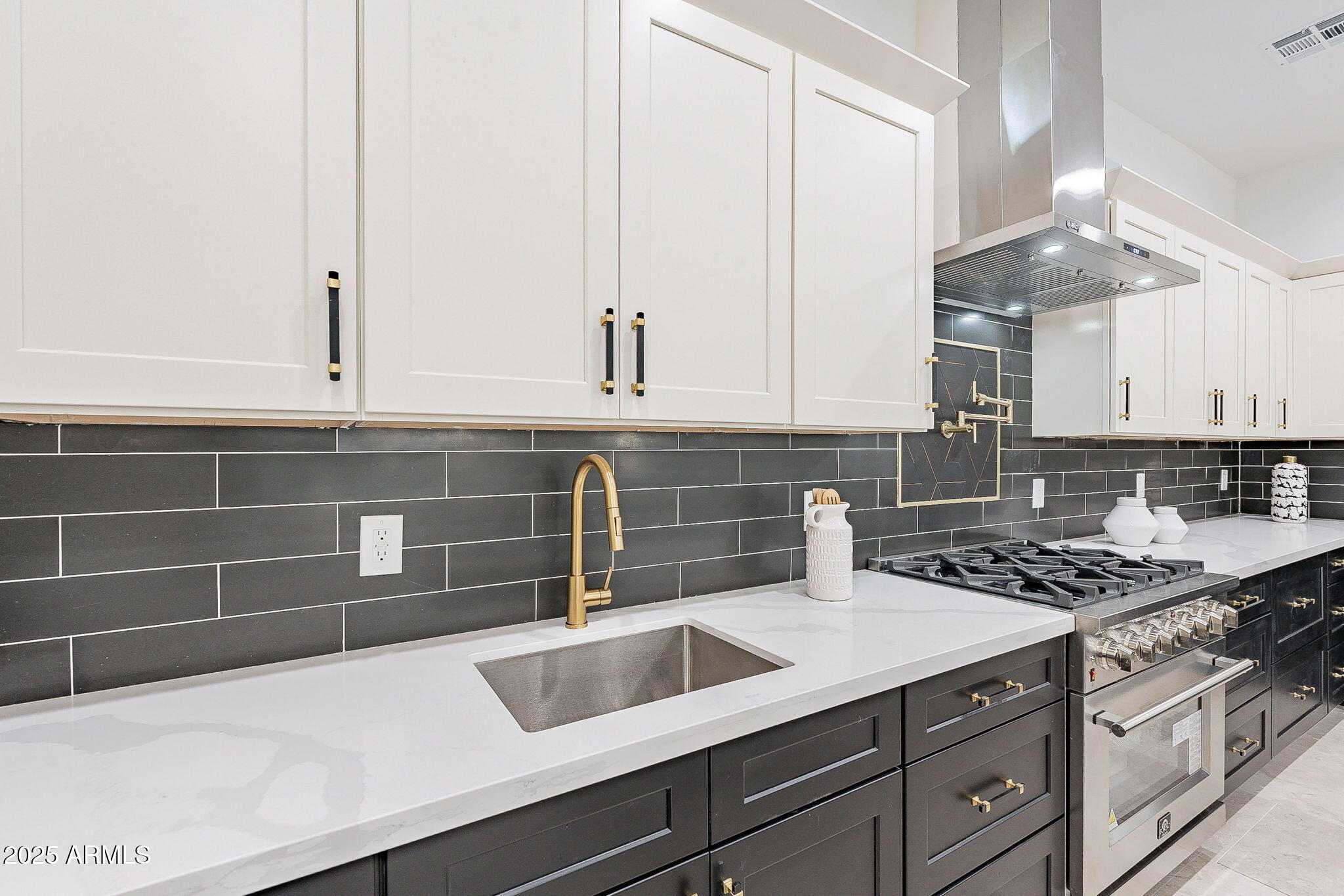 707 East Ocotillo Road Phoenix, AZ 85014 - Photo 26 of 59 a kitchen with stainless steel appliances a sink a stove and white cabinets