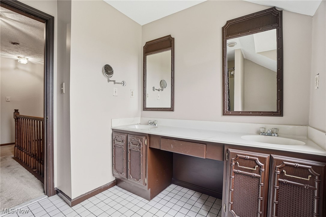 11710 Butternut Road Chardon, OH 44024 - Photo 35 of 48 Bathroom featuring double vanity and light tile patterned floors