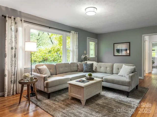 a living room with furniture and a large window