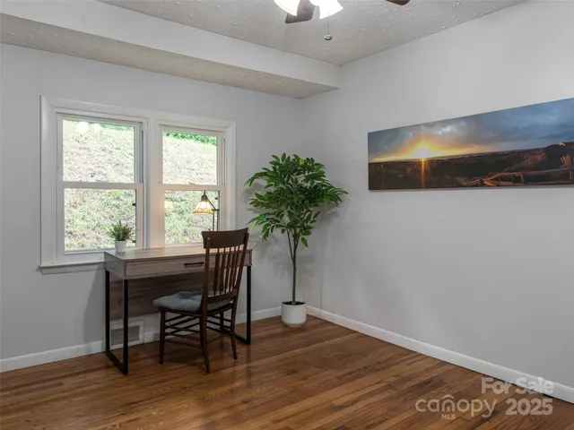 a workspace with furniture and a potted plant