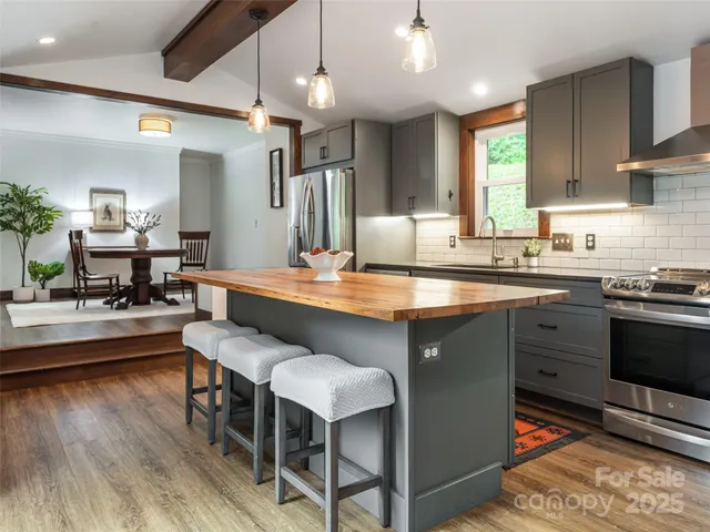 a kitchen with a sink appliances and cabinets