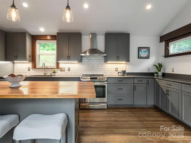 a kitchen with stainless steel appliances granite countertop a sink counter space and cabinets