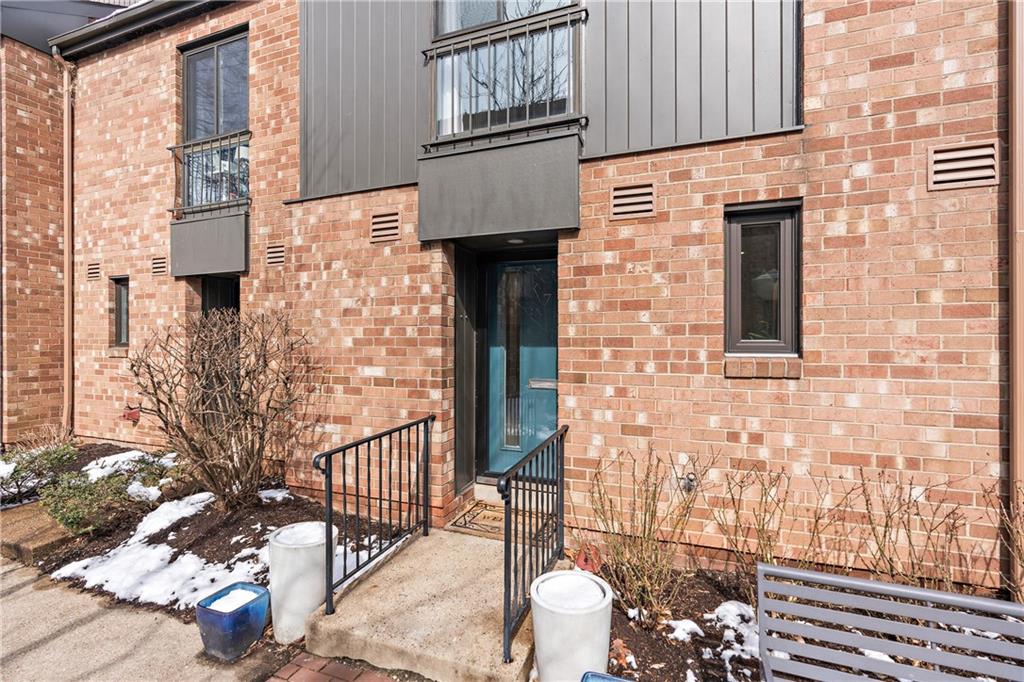 a brick building with a street sign on the side of it