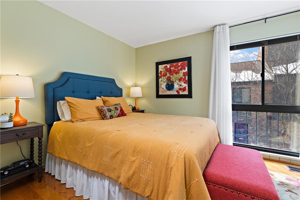 7 Foster Square Pittsburgh, PA 15212 - Photo 14 of 22 a bed sitting in a bedroom next to a window