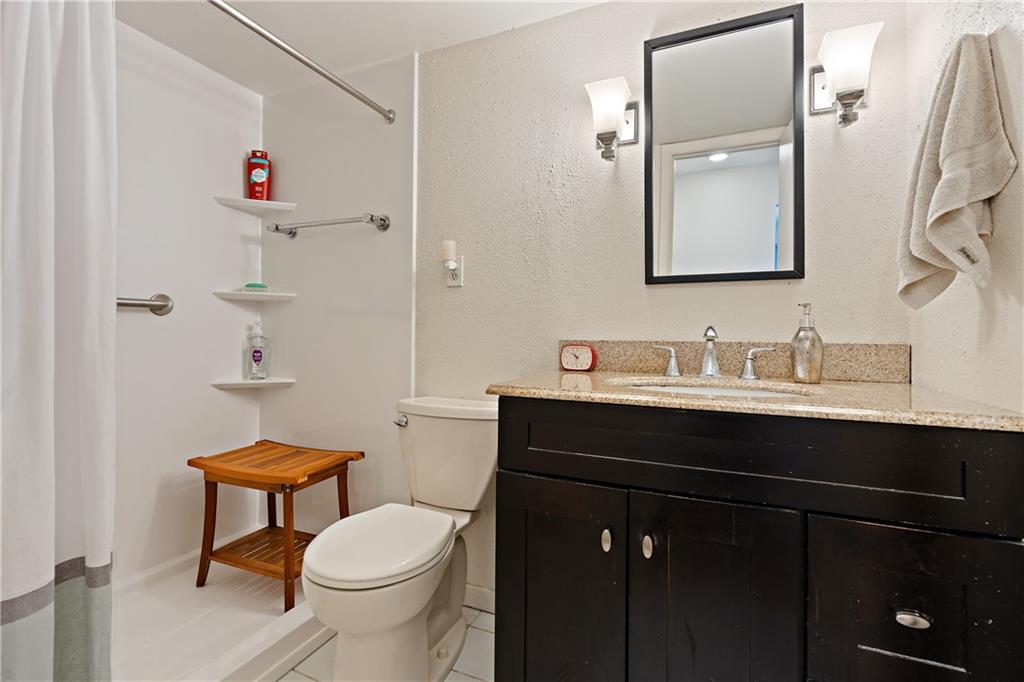 7 Foster Square Pittsburgh, PA 15212 - Photo 19 of 22 a bathroom with a sink vanity mirror and toilet