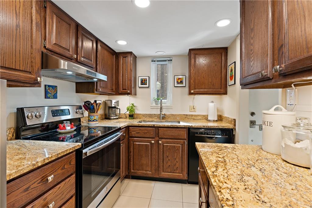 7 Foster Square Pittsburgh, PA 15212 - Photo 8 of 22 a kitchen with stainless steel appliances granite countertop a sink stove top oven and cabinets