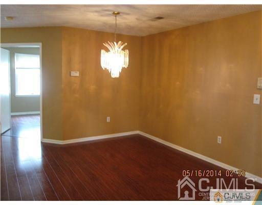 1023 Edpas Road New Brunswick, NJ 08901 - Photo 3 of 10 a view of an empty room with wooden floor and a window