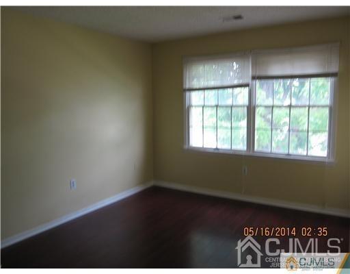 1023 Edpas Road New Brunswick, NJ 08901 - Photo 5 of 10 an empty room with wooden floor and windows