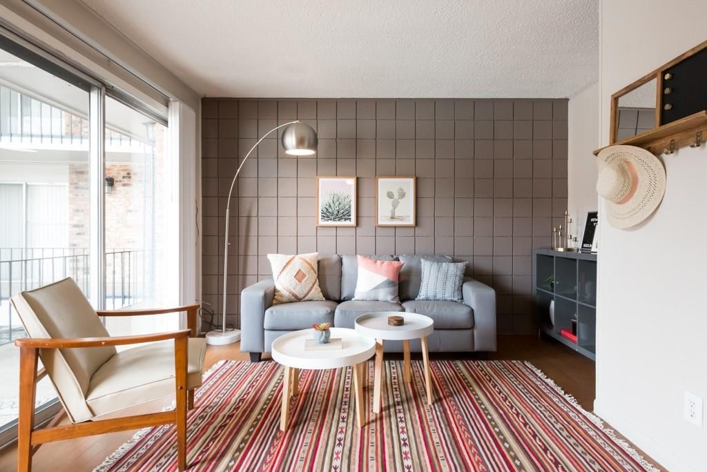 a living room with furniture and a wooden floor
