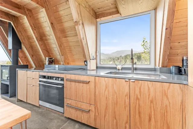 a living room with furniture and floor to ceiling windows