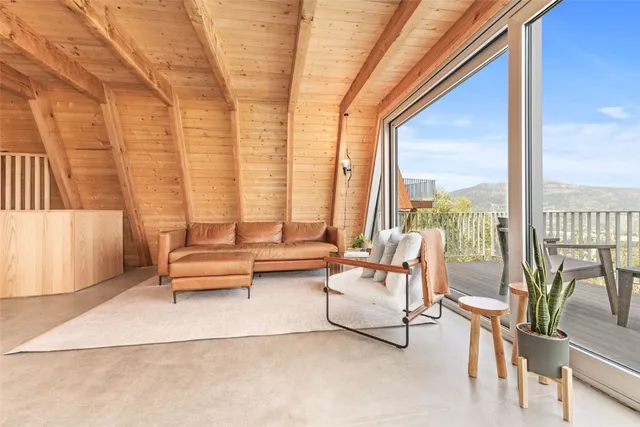 a living room with furniture and a floor to ceiling window