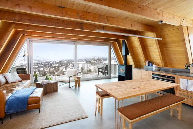 a balcony with wooden floor table and chairs