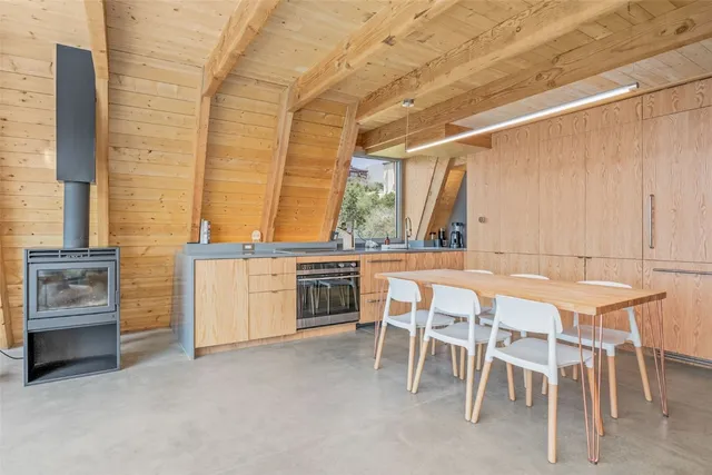 a kitchen with stainless steel appliances kitchen island a stove a sink and white cabinets