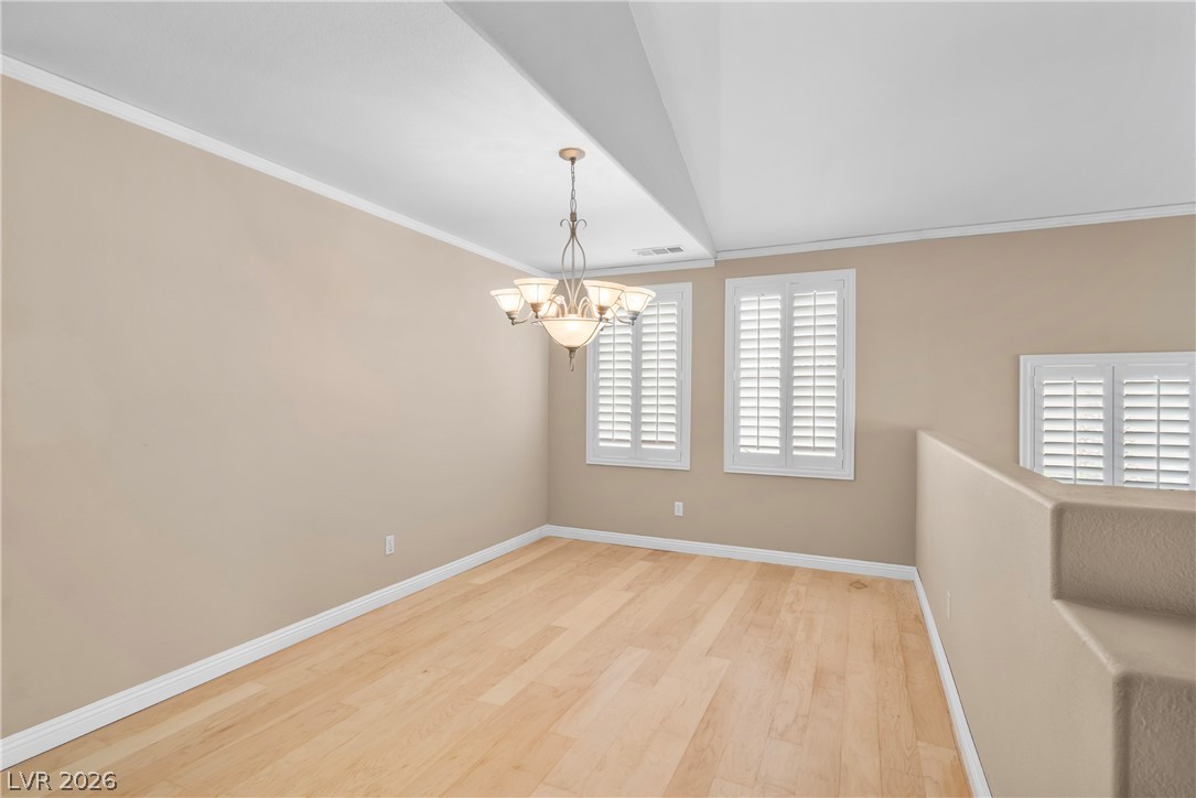 708 Vortex Avenue Henderson, NV 89002 - Photo 9 of 71 A well-lit interior space features hardwood flooring and plantation shutters.