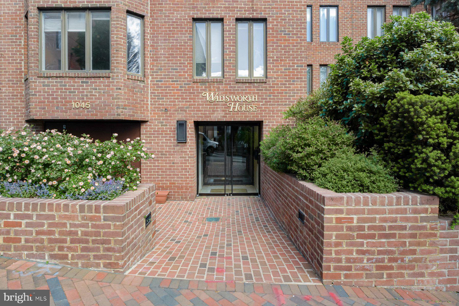 1045 31st Street Northwest, Unit 303 Washington, DC 20007 - Photo 1 of 12 a front view of a house with a garden