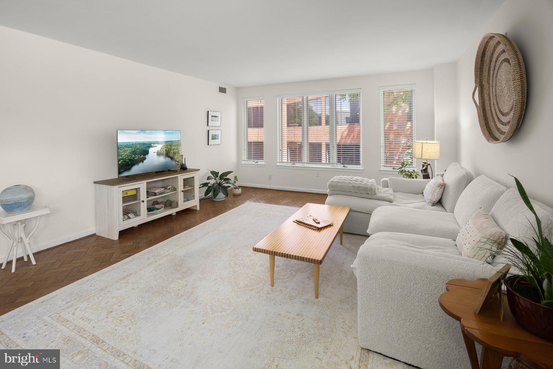 1045 31st Street Northwest, Unit 303 Washington, DC 20007 - Photo 4 of 12 a living room with furniture a flat screen tv and a window