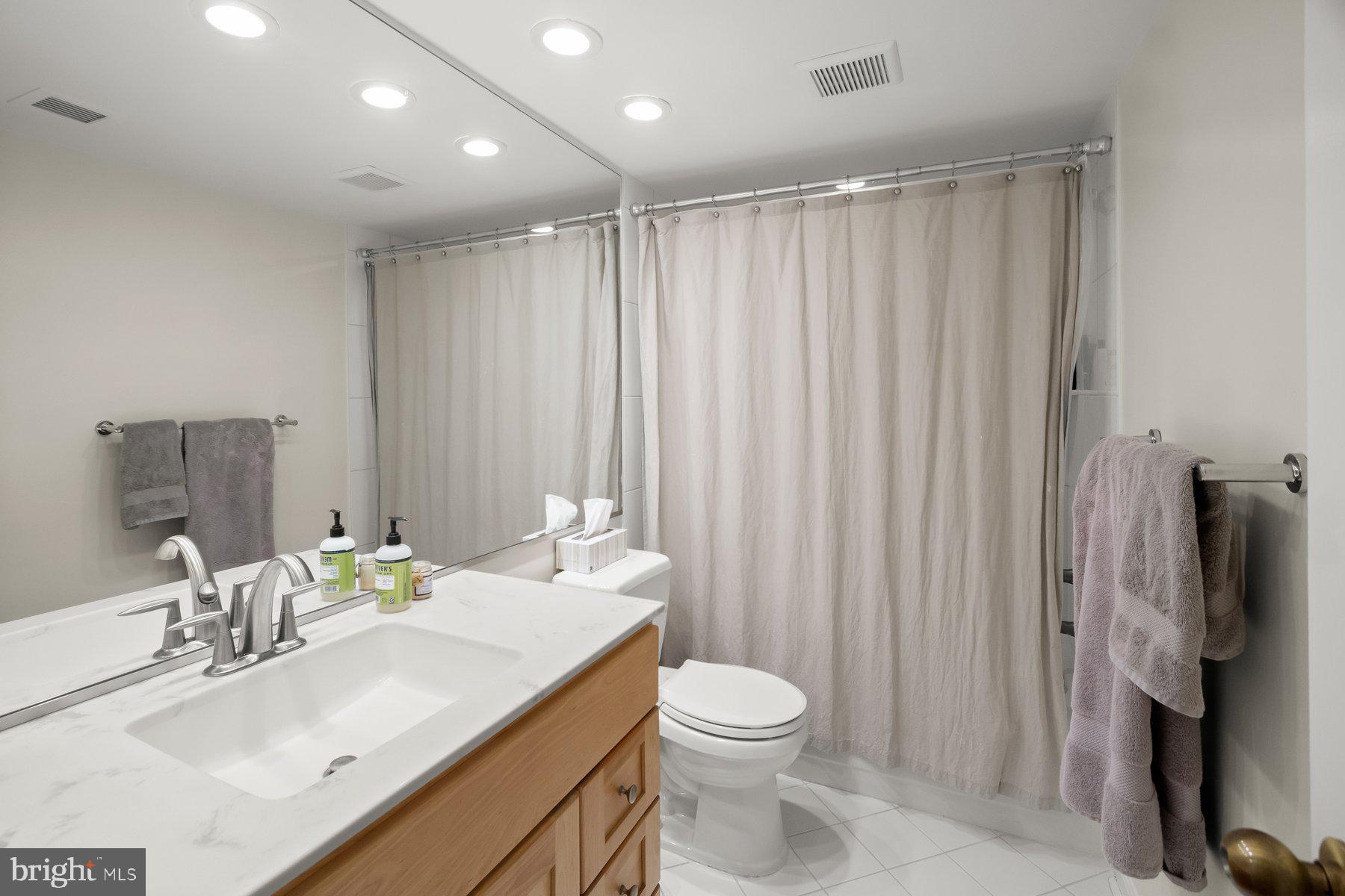 1045 31st Street Northwest, Unit 303 Washington, DC 20007 - Photo 10 of 12 a bathroom with a sink toilet and shower