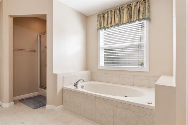 a bathroom with a bathtub and a window