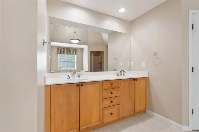 a bathroom with double sink and a mirror