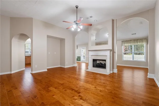 a view of a room with chandelier fan and fire place