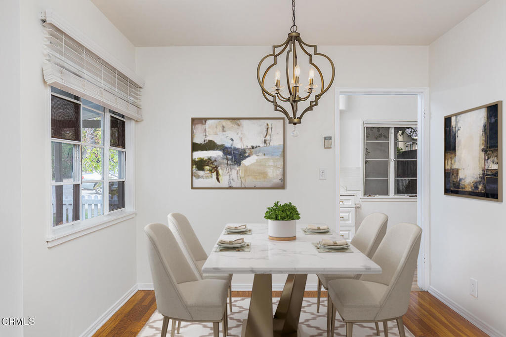 1070 East Woodbury Road Pasadena, CA 91104 - Photo 11 of 28 a view of a dining room with furniture wooden floor and chandelier