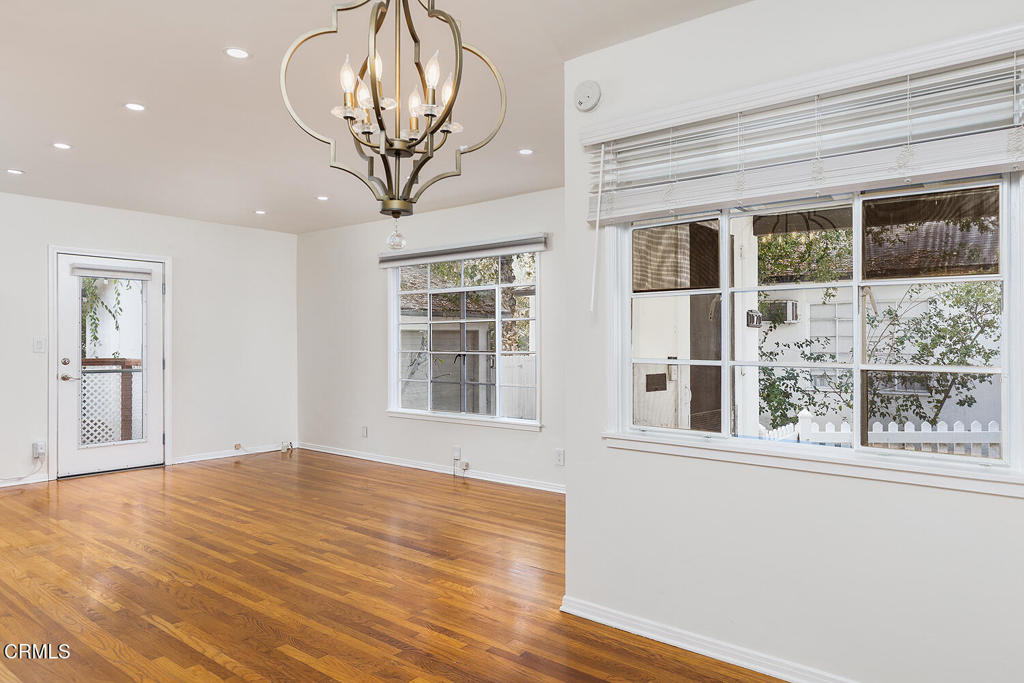 1070 East Woodbury Road Pasadena, CA 91104 - Photo 13 of 28 a view of empty room with wooden floor and fan