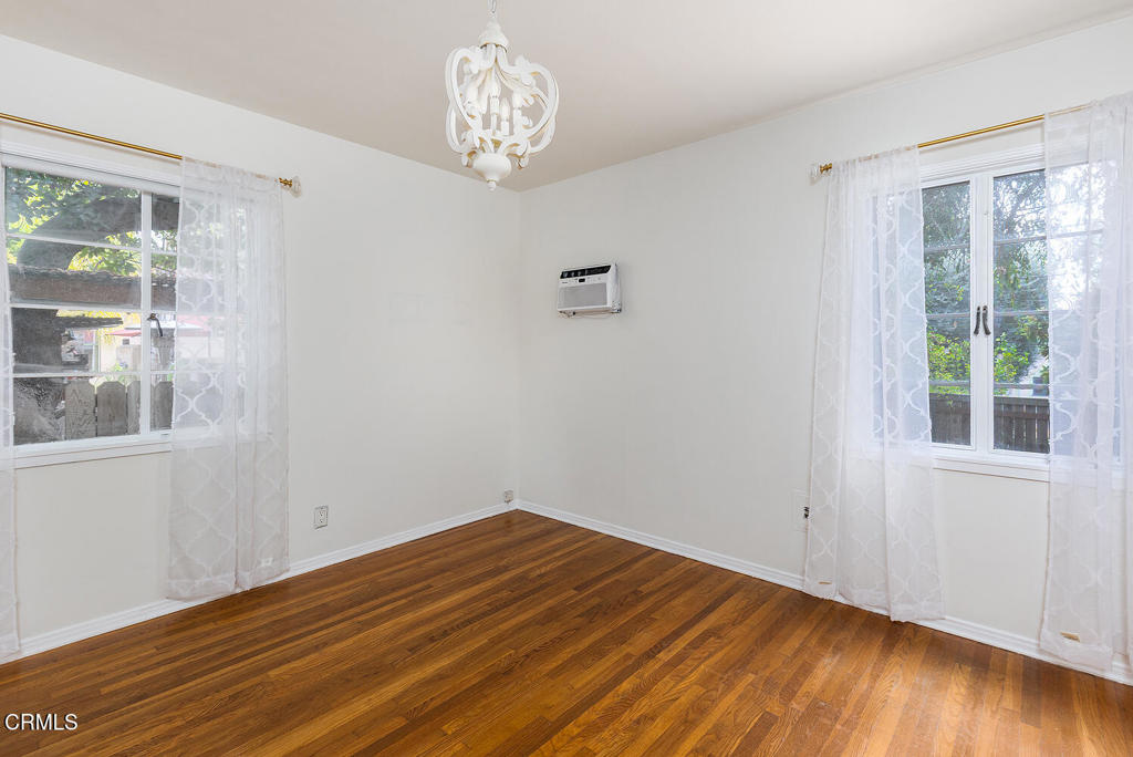 1070 East Woodbury Road Pasadena, CA 91104 - Photo 19 of 28 a view of empty room with wooden floor and fan