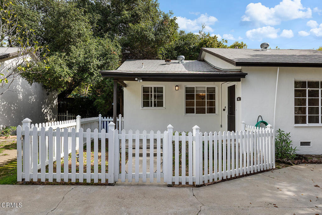 1070 East Woodbury Road Pasadena, CA 91104 - Photo 2 of 28 a front view of a house with a garden