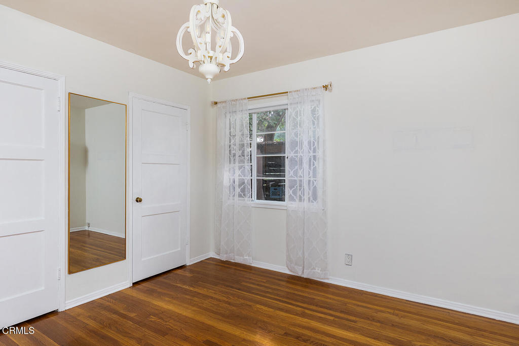 1070 East Woodbury Road Pasadena, CA 91104 - Photo 21 of 28 a view of empty room with wooden floor and fan
