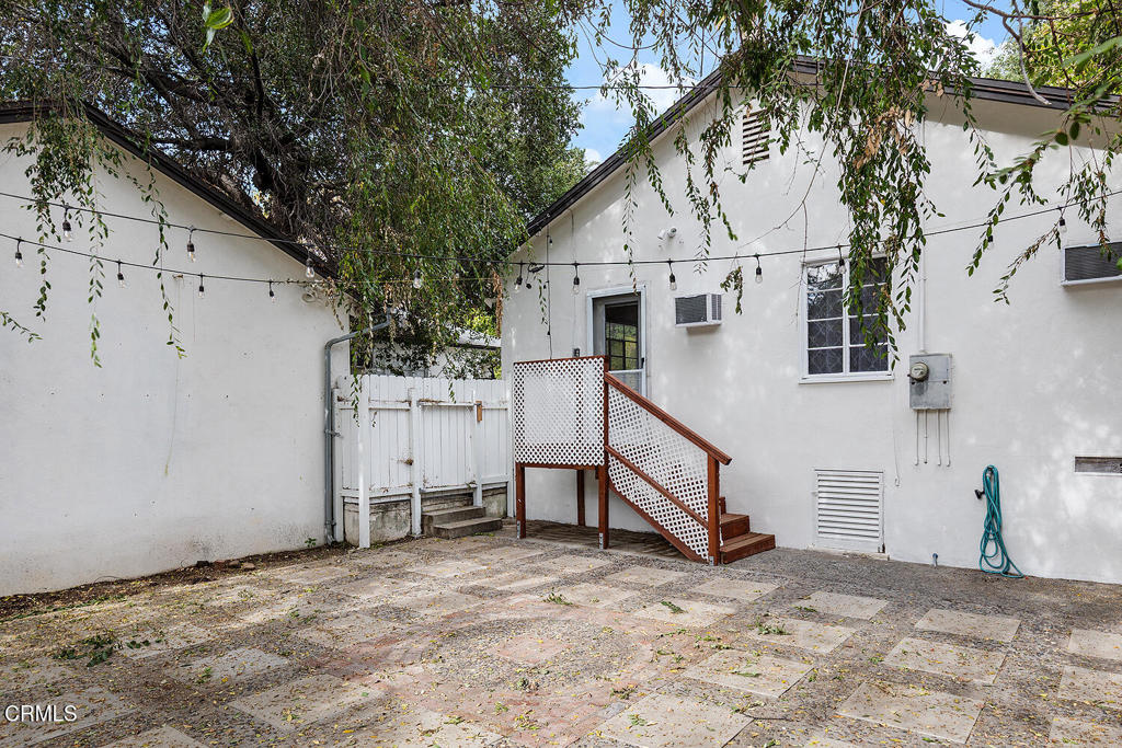 1070 East Woodbury Road Pasadena, CA 91104 - Photo 25 of 28 a view of white house with a yard and garage