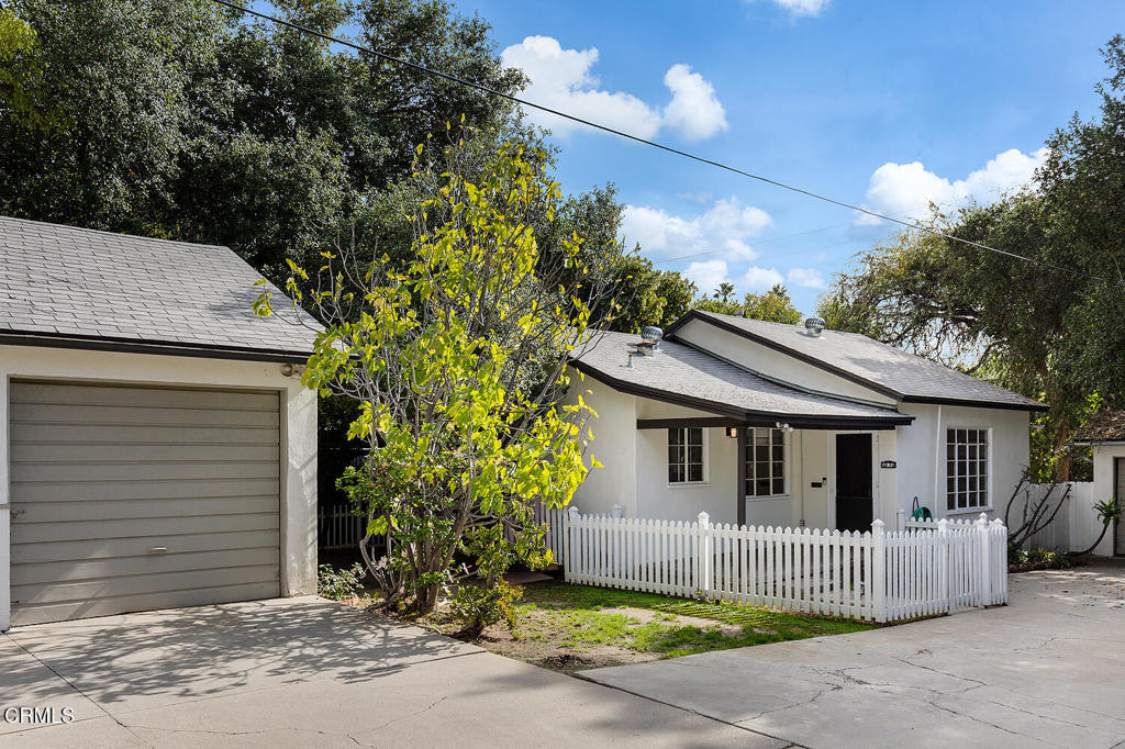 1070 East Woodbury Road Pasadena, CA 91104 - Photo 26 of 28 a front view of a house with a garden