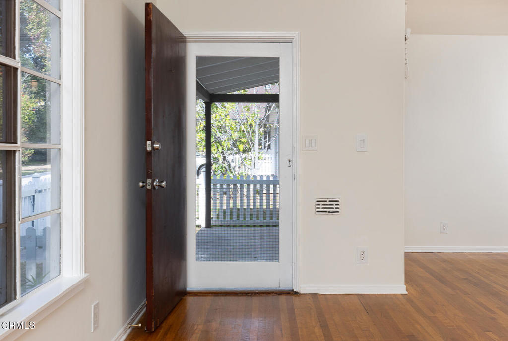 1070 East Woodbury Road Pasadena, CA 91104 - Photo 4 of 28 a view of a hallway with wooden floor and a window