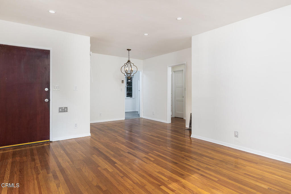 1070 East Woodbury Road Pasadena, CA 91104 - Photo 10 of 28 an empty room with wooden floor and windows