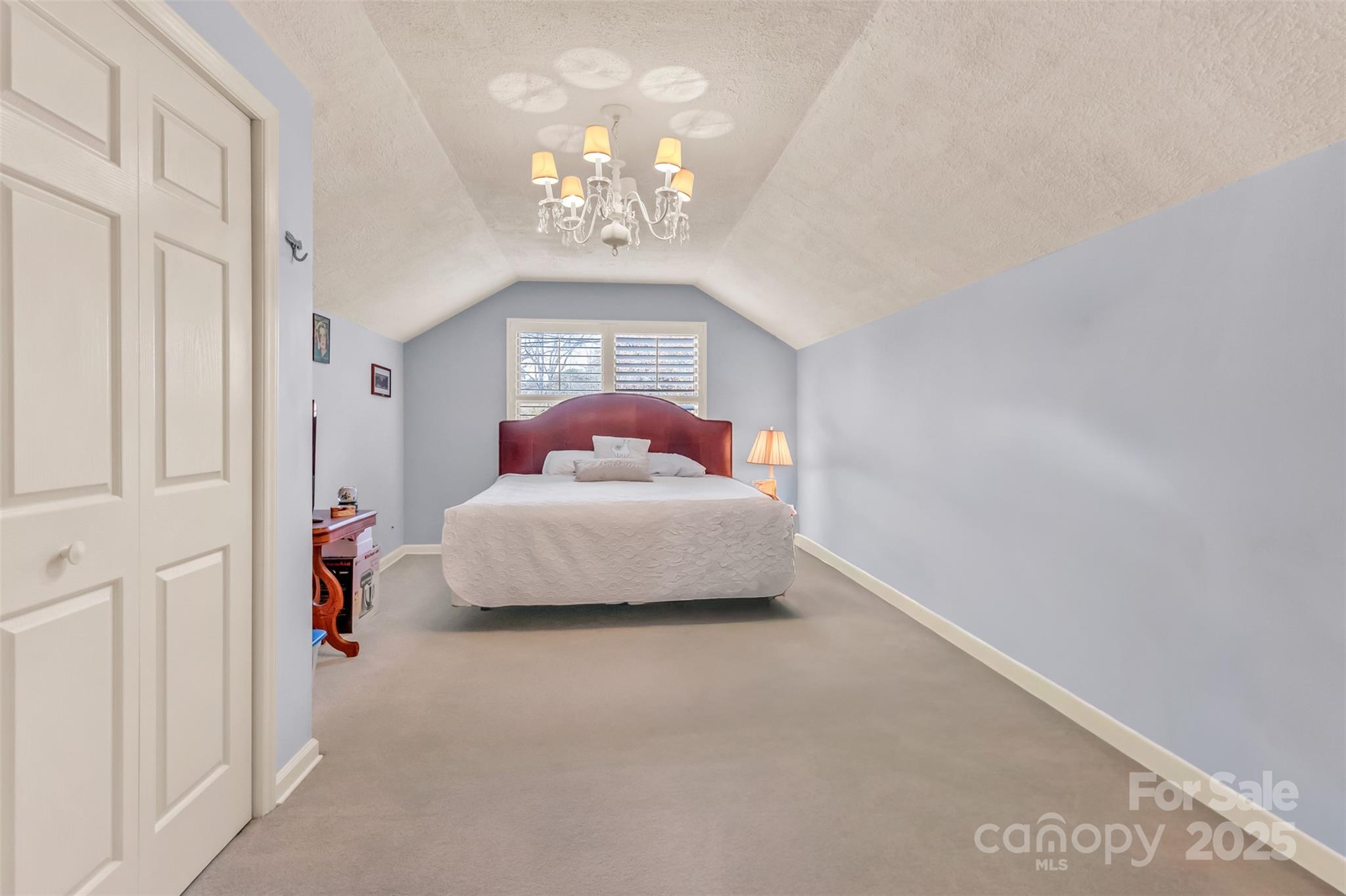 3 Lake Ridge Road Clover, SC 29710 - Photo 30 of 41 a bedroom with a bed and a chandelier