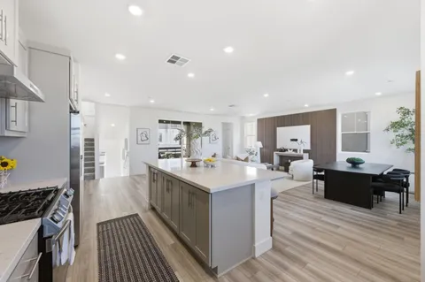 a kitchen with a sink and wooden floor