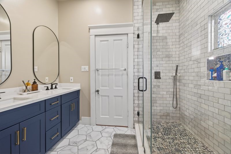 1414 Finch Street Houston, TX 77009 - Photo 20 of 24 The bathroom has been beautifully renovated with a modern, spacious design featuring a stunning walk-in shower, combining contemporary style with comfort and functionality.